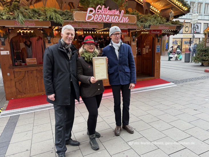 Pr&auml;miert als sch&ouml;nster Stand 2025: Birgit und Josef Rohrer von den Beerenalm auf dem M&uuml;nchner Christkindlmarkt erhielten eine Urkunde von Kurt Kapp (stellv. Leiter Referat f&uuml;r Arbeit und Wirtschaft, re.)  (&copy;Foto: Martin Schmitz)